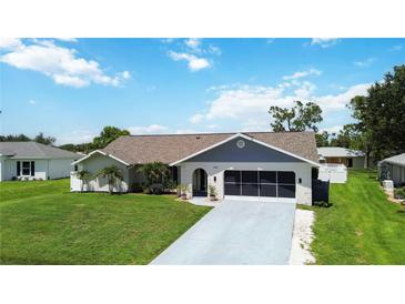 Charming single-story home with a well-manicured lawn and attached garage, great curb appeal at 1498 Truval Ter, Port Charlotte, FL 33952