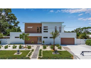 Modern two-story home showcasing a minimalist design, desert-style landscaping, and a two-car garage at 2124 Clematis Pl, Sarasota, FL 34239
