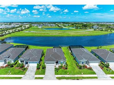 Beautiful aerial view of homes surrounding a scenic lake in a vibrant community at 4324 Dairy Ct, Lakewood Ranch, FL 34211