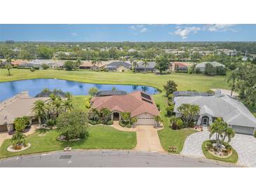 Stunning aerial view of a home with a lake, golf course and lush landscaping in a beautiful community at 4330 Presidential Avenue E Cir, Bradenton, FL 34203