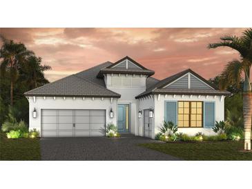 Beautiful single-Gathering home boasting a two-car garage, white exterior, and lovely tropical landscaping at 6204 Isla Del Ray Ave, Sarasota, FL 34240