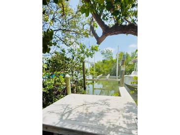 Private boat dock and boat lift provide waterfront access and easy boating from your backyard at 8301 Marina Dr # 10, Holmes Beach, FL 34217