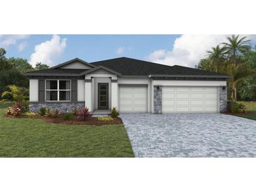Charming single-story home with a three-car garage and stone accents at 17146 James Trl, Parrish, FL 34219