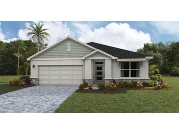 Charming single-story home featuring a well-manicured lawn, stone accents, and a two-car garage at 1766 Cobb Trl, Parrish, FL 34219