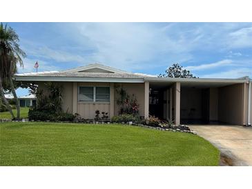 Charming single-story home with a well-manicured lawn, mature landscaping and convenient covered parking at 3262 Brunswick Ln # 707, Sarasota, FL 34239