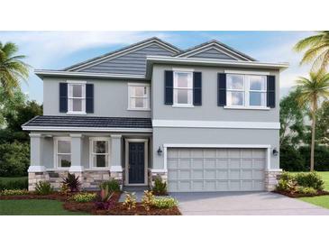 Beautiful two-story home featuring a stylish gray exterior, well-manicured landscaping, and an attached two-car garage at 18329 Thistleberry Pl, Lakewood Ranch, FL 34211