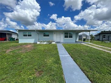 Charming single story home with a well-maintained lawn and inviting front entrance at 22214 Felton Ave, Port Charlotte, FL 33952