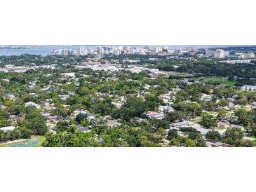 Stunning aerial view of the lush neighborhood and cityscape beyond this single Gathering home at 2590 Floyd St, Sarasota, FL 34239