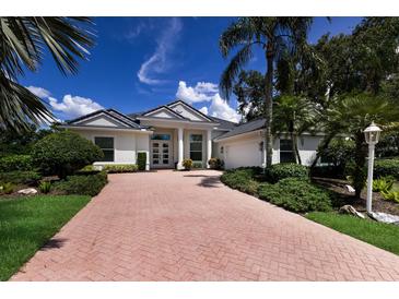 Stunning single-story home with a beautifully landscaped yard and inviting brick driveway at 7211 Marston Ct, University Park, FL 34201