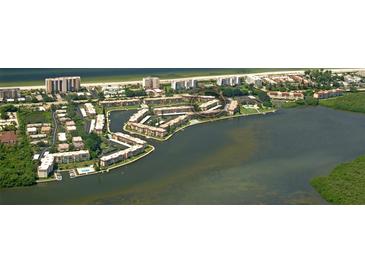 Waterfront condos with pools, docks, and tropical landscaping offer a luxurious coastal living experience at 4380 Exeter Dr # 204, Longboat Key, FL 34228