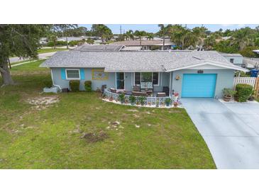 Charming single-story home with a well-manicured lawn, a bright blue garage door, and inviting front patio at 453 Sandlewood Dr, Venice, FL 34293