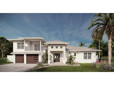 Elegant two-story home with a manicured lawn, two-car garage, and lush tropical landscaping at 8006 20Th W Pl, Bradenton, FL 34209