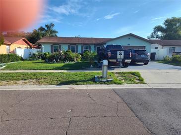 Charming single-story home with a well-manicured lawn and inviting curb appeal with driveway parking at 1209 Croydonwood Cir, Brandon, FL 33510