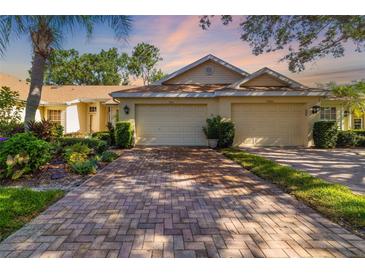 Charming single-story home with a well-manicured front yard and a two-car garage at 2411 New Haven Cir # 70, Sun City Center, FL 33573
