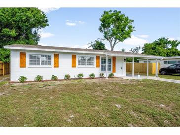 Charming single-story home with tidy landscaping, white exterior, and wood-style shutters at 2802 21St W St, Bradenton, FL 34205