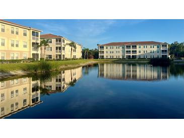 Beautiful condo community with lake reflecting buildings on a sunny day at 500 San Lino Cir # 534, Venice, FL 34292
