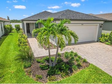 Charming single-story home featuring a well-maintained front yard and a two-car garage at 6612 Silverstar Dr, Sarasota, FL 34240