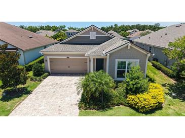 Charming single-story home features a manicured lawn and a welcoming two-car garage at 11223 Spring Gate Trl, Bradenton, FL 34211