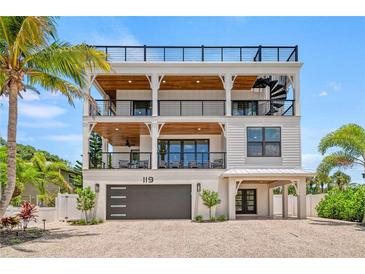 Stunning three-story beach house with a spiral staircase and multiple balconies at 119 Avenida Messina, Sarasota, FL 34242