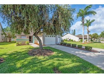 Charming single-story home with lush landscaping, mature tree, and a well-maintained lawn at 327 40Th W Ct, Palmetto, FL 34221