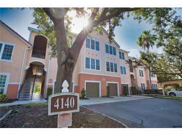 Attractive condo building with garages and inviting exterior features and verdant trees at 4140 Central Sarasota Pkwy # 1235, Sarasota, FL 34238