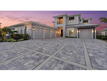 Stunning home boasts a spacious driveway, three-car garage, and manicured landscaping at 676 Regatta Way, Bradenton, FL 34208