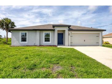 Charming single-story home with a well-manicured lawn and a welcoming blue front door at 8429 Malcolm Ave, North Port, FL 34287