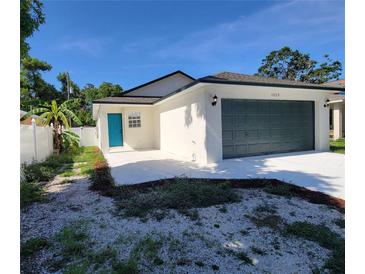 Charming single-story home with a well-manicured lawn and a vibrant blue front door at 1019 34Th W Ave, Bradenton, FL 34205