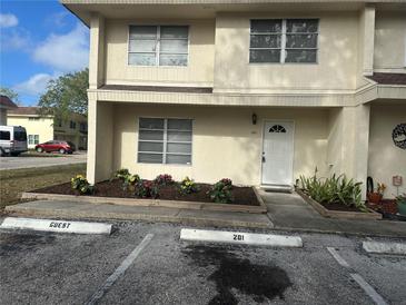 Charming townhouse featuring tidy landscaping and reserved guest parking at 201 Elliot Ave, Sarasota, FL 34232
