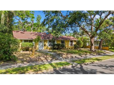Charming single-story home with a well-maintained lawn and mature trees providing ample shade at 218 32Nd W St, Bradenton, FL 34205
