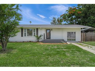 Charming one-story home with well-maintained lawn and inviting front porch at 3310 W 9Th Ave, Bradenton, FL 34205
