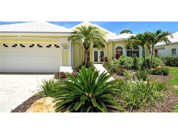 Charming, yellow single-Gathering home with a well-manicured front yard and bright white trim at 340 Bermuda Ct # 5, Venice, FL 34293