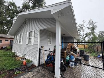 View of the side of the home, showing the siding, windows and fenced-in backyard at 400 Tweed Ave, Seffner, FL 33584