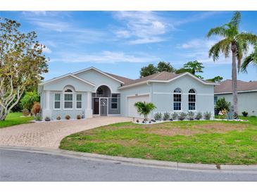 Charming single-story home with well-manicured lawn, stone-paved driveway, and lush tropical landscaping at 5139 50Th W Ave, Bradenton, FL 34210