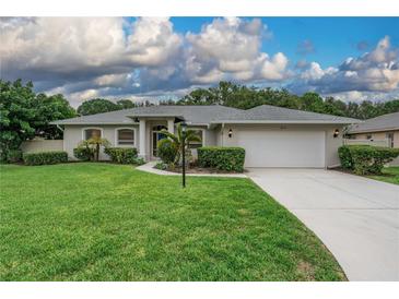Charming single-story home featuring a well-manicured lawn and attached two-car garage at 813 Oak Pond Dr, Osprey, FL 34229