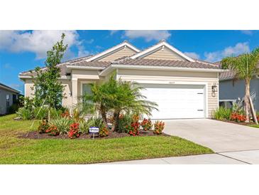 Charming single-Gathering home featuring well-maintained landscaping, healthy lawn, and a two car garage at 10177 Crystal Isle Cir, Sarasota, FL 34241
