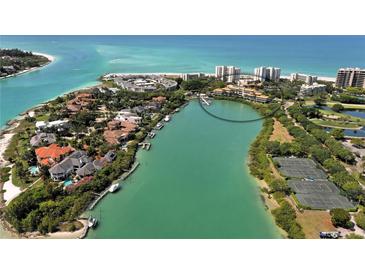 Stunning aerial view of waterfront homes along lush green waterways and Gulf beaches at 225 Sands Point Rd # 6201, Longboat Key, FL 34228