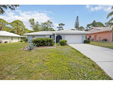 Charming single-story home with well-maintained lawn and mature landscaping at 307 Rubens Dr, Nokomis, FL 34275