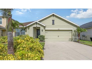 Charming one-story home with a two-car garage, front yard landscaping, and a welcoming entrance at 3813 Willow Branch Pl, Palmetto, FL 34221