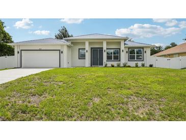 Beautiful single-story home featuring a well-manicured lawn and a charming, modern exterior design at 4855 Dragon St, North Port, FL 34288