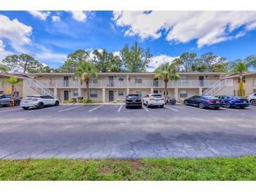 Two-story condo building featuring well-maintained landscaping, ample parking, and private entrances to each unit at 924 La Costa Cir # 4, Sarasota, FL 34237