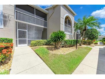 Charming condo exterior with a well-maintained lawn and screened in porch at 9580 High Gate Dr # 1822, Sarasota, FL 34238