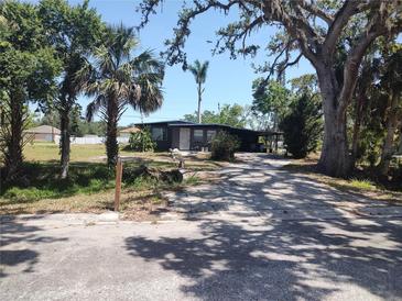 Charming single-story home with mature trees and a long driveway at 1423 17Th E Ave, Bradenton, FL 34208