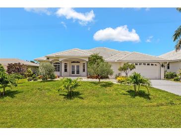 Charming single-story home with lush green lawn and meticulously landscaped front yard at 3615 Tripoli Blvd, Punta Gorda, FL 33950