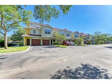 Charming townhomes with red tile roofs, attached garages and well-maintained landscaping at 5001 Baraldi Cir # 22-202, Sarasota, FL 34235