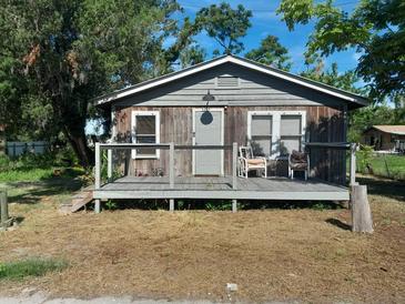 Charming single-story home featuring a rustic exterior with a welcoming porch and two chairs at 5332 22Nd E St, Bradenton, FL 34203