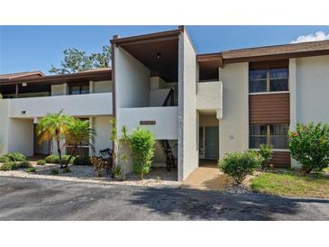 Condo exterior with manicured landscaping, private entry, and visible unit number at 6061 Fairway Ln # 1411, Bradenton, FL 34210