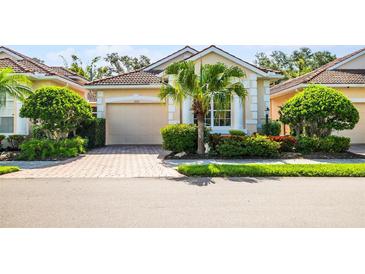 Charming single-story home with beautiful landscaping and a brick paver driveway, providing curb appeal at 7747 33Rd E St, Sarasota, FL 34243
