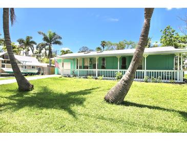 Inviting single story home featuring a spacious lawn and charming porch at 12107 45Th W Ave, Cortez, FL 34215
