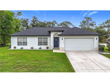 Charming single-story home features a well-manicured lawn and attached two-car garage at 4148 Lobelia St, North Port, FL 34286